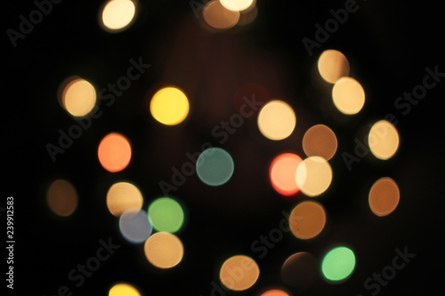 Blurred defocused christmas light lights bokeh background. Colorful red yellow blue green de focused glittering pattern concept.