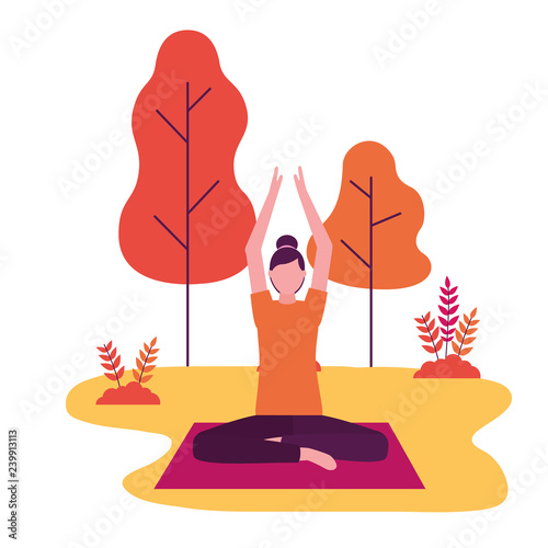 woman practicing yoga on mat in the park