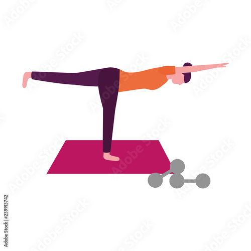 woman making yoga with mat and dumbbells