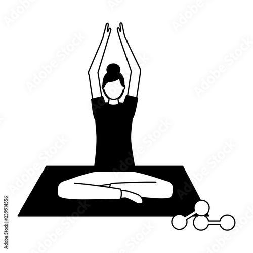 woman making yoga with mat and dumbbells