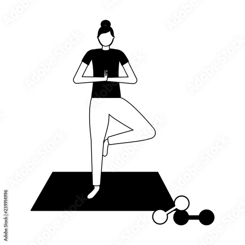 woman making yoga with mat and dumbbells