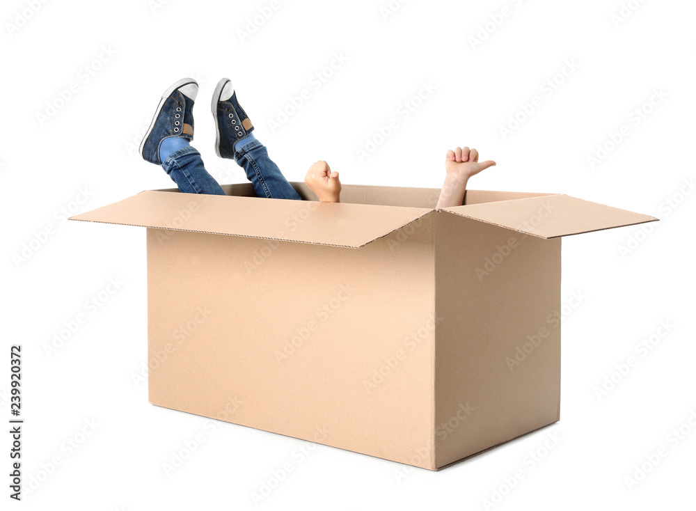 Cute little child playing with cardboard box on white background