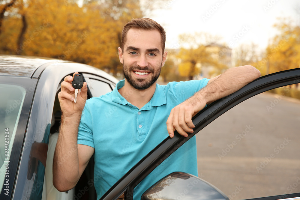 © New Africa - Young man holding car key near auto. Driving license test © New Africa - Young man holding car key near auto. Driving license test