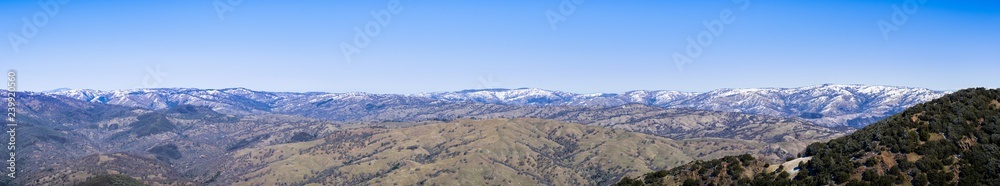 Panoramic view of the Ohlone Wilderness, part of the mountains in the Diablo Range, covered in a thin layer of snow on a winter morning; as seen from Mt Hamilton, San Jose, San Francisco bay area