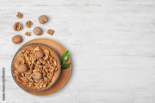 Flat lay composition with tasty walnuts and space for text on wooden background