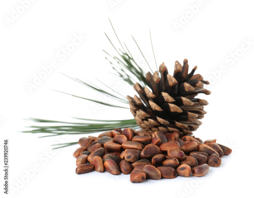 Obraz na płótnie Heap of pine nuts and cone on white background