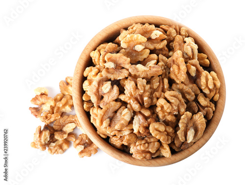 Bowl with walnuts on white background, top view