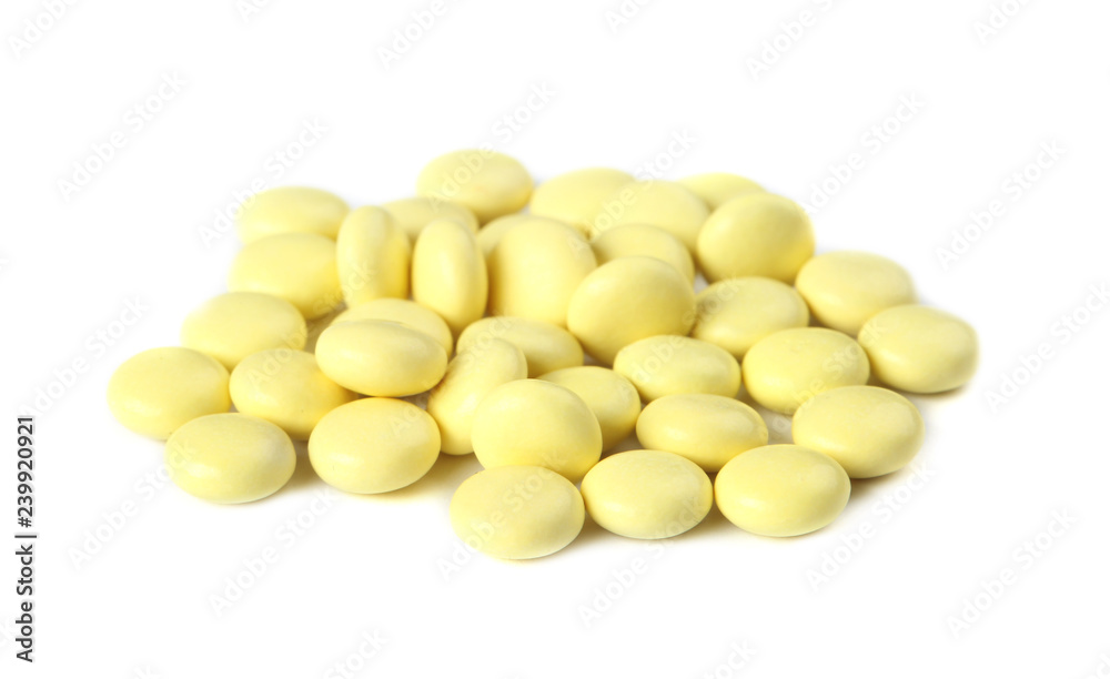 Pile of yellow pills on white background. Medical care and treatment Pile of yellow pills on white background. Medical care and treatment