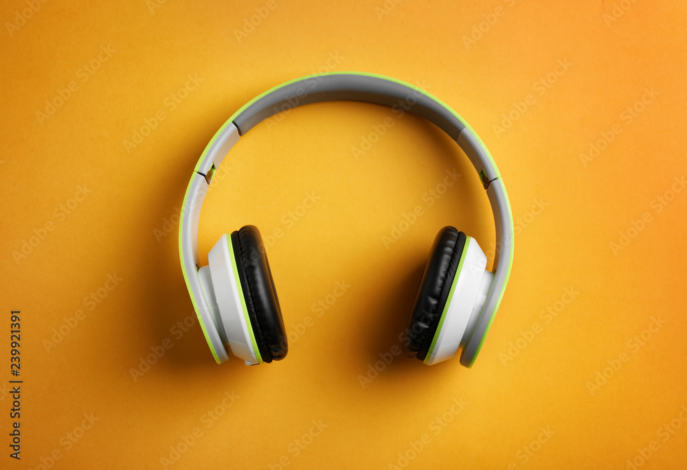 Wireless headphones on color background, top view Wireless headphones on color background, top view