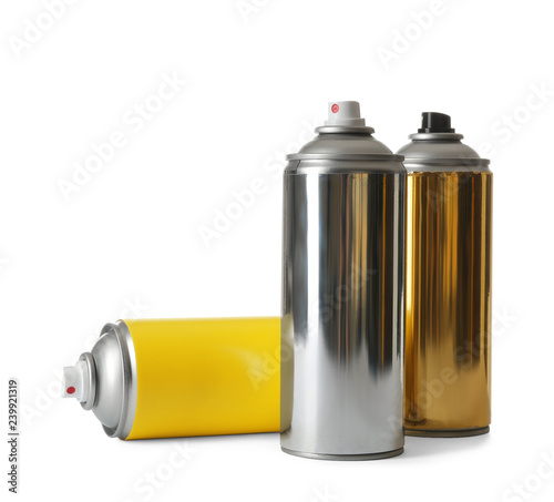 Cans of different spray paints on white background