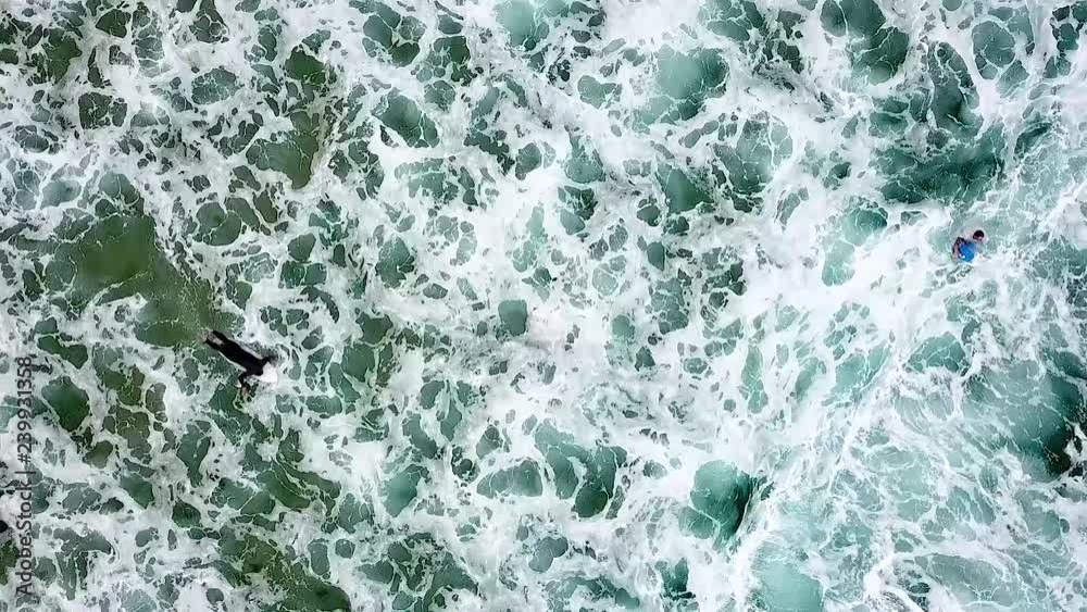White wash adn surfers at Maroubra beach, Australia. Aerial shot hovering over the surfers.