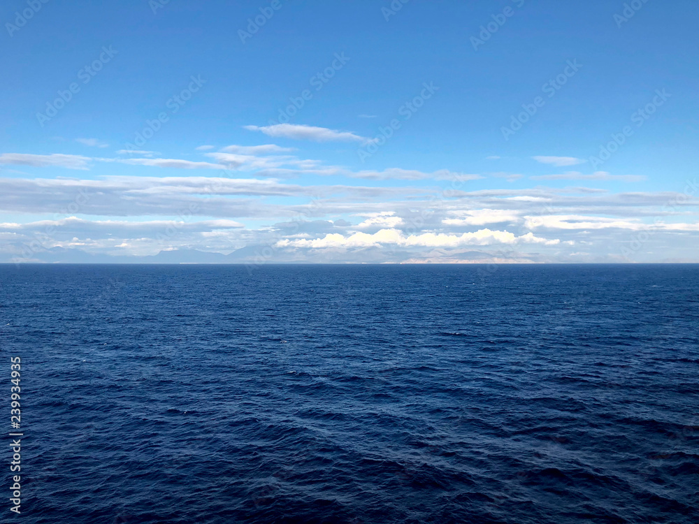 Horizon in the Andriatic blue sea and beautiful white clouds. A look at the horizon in the open sea. Cropped shot, horizontal, empty space, concept of leisure and travel
