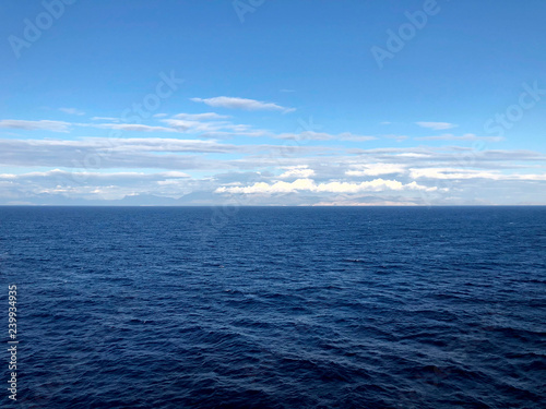 Horizon in the Andriatic blue sea and beautiful white clouds. A look at the horizon in the open sea. Cropped shot, horizontal, empty space, concept of leisure and travel © Nataliia