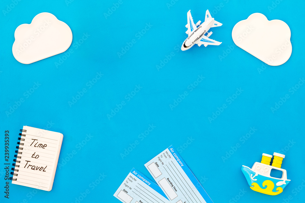 children tourism outfit with tickets, notebook and toys blue background flat lay mockup. Time to travel.