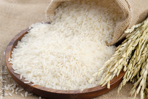 Rice was poured out of a sack on a wooden tray.