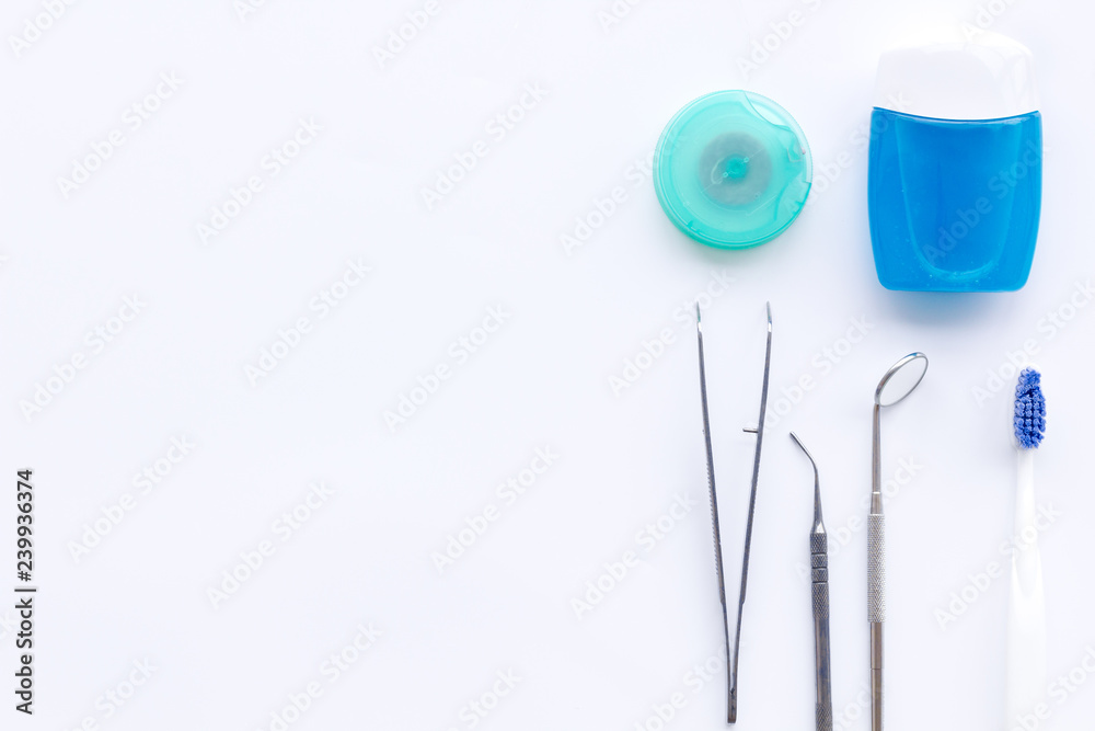 Daily oral hygiene for family. Toothbrush, dental floss and dentist instruments on white background top view space for text