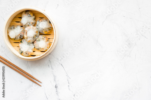 Chinese food set with dim sum, sticks on marble background top view copy space