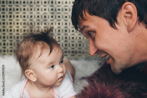 portrait of father and newborn babyhat face to face. photo