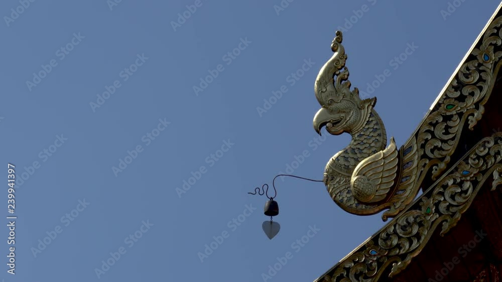 Part of traditional roof with brass bell in Thai temple Part of traditional roof with brass bell in Thai temple