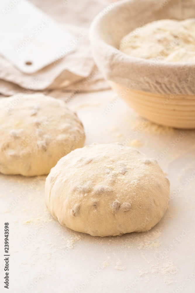Balls of dough covered with wheat flour ready for baking. Copy space. Balls of dough covered with wheat flour ready for baking. Copy space.
