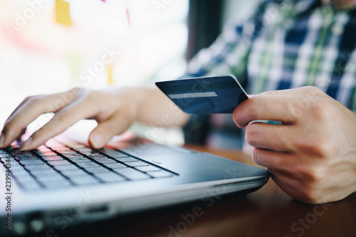 Man with laptop and credit card for shopping online. Pays for purchase.online shopping, online payment,buy and sell products & services