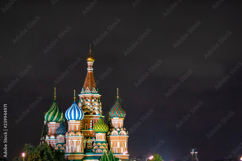 Colourful Saint Basilic Cathedral at night in Moscow, Russia. Bright onion shaped domes isolated on a black background