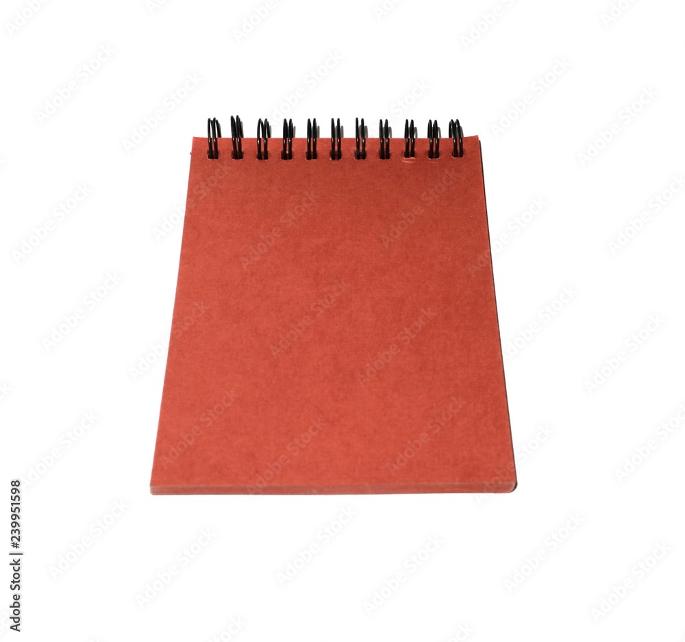 The red paper notebook is isolated on a white background. The red paper notebook is isolated on a white background.