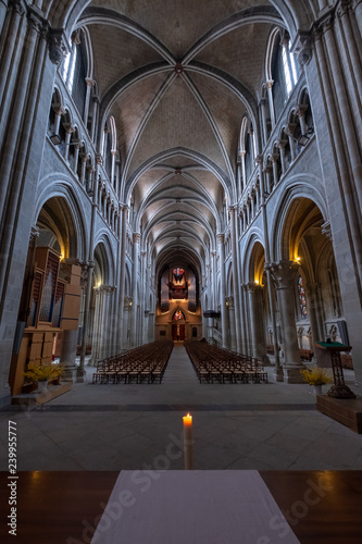 Interior of catholic cathedral  candle at foreground