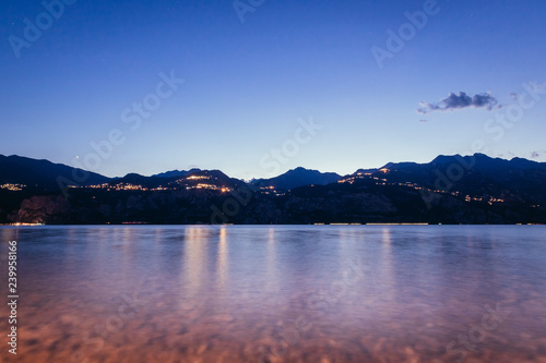 Evening scene at lago di garda: Lake, rocks and village