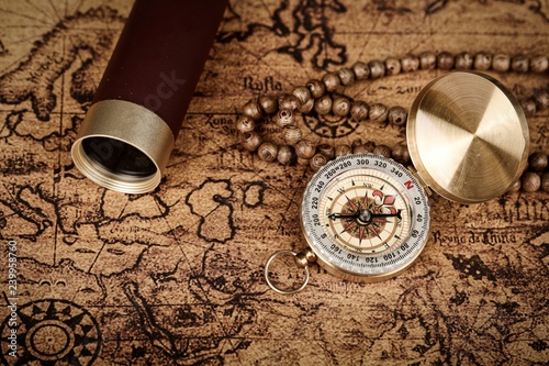 Vintage compass and spyglass telescope on old map - Explorer concept