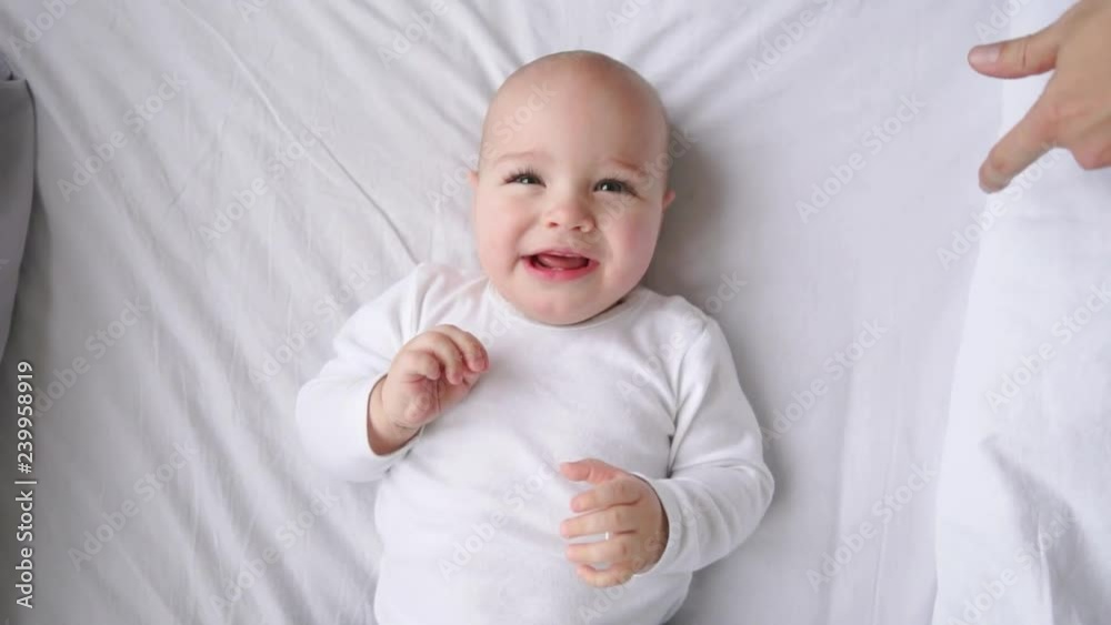 Cute little baby lying on bed, top view Cute little baby lying on bed, top view