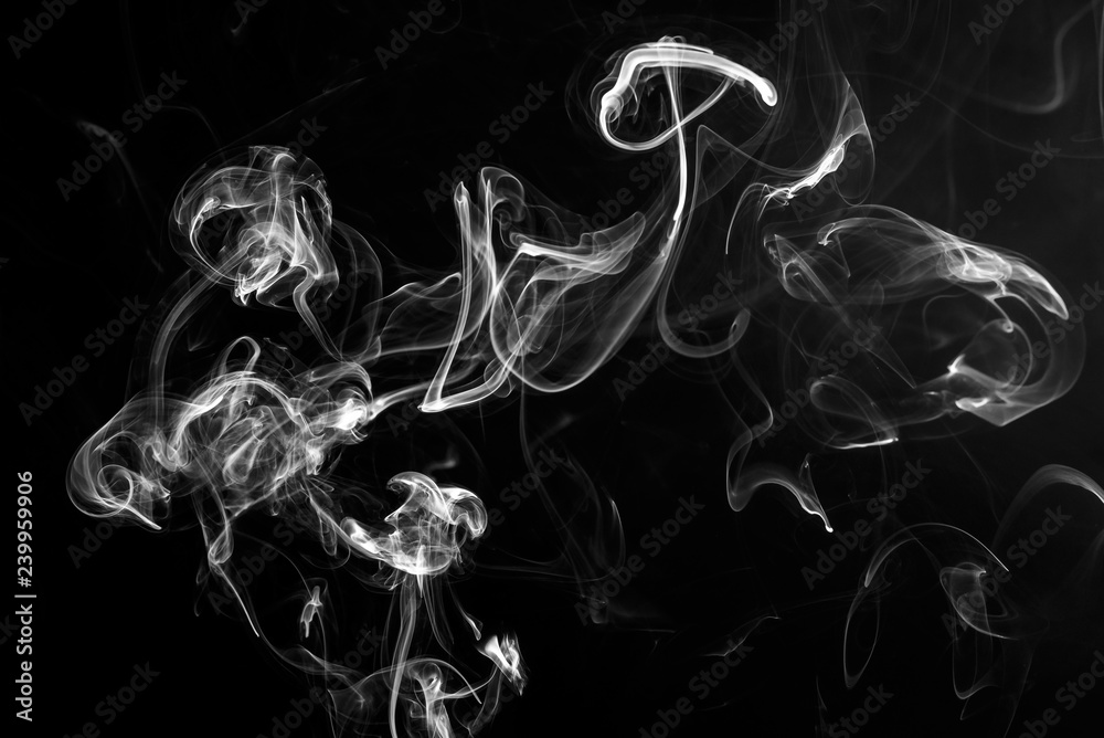 Cigarette smoke close up on a black background, abstract background Cigarette smoke close up on a black background, abstract background