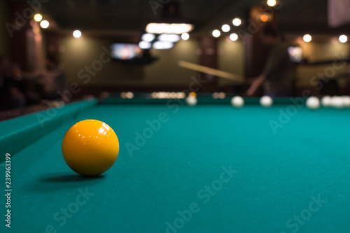 The game of American and Russian billiards. Pool table, ball and cue. Sports leisure. Friendly tournament. Winter fun. Green cloth in billiards. Luza for the ball. Aim and beat. Cue kick.