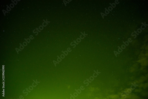 Obraz na plátne Night sky stars and clouds / The green sky with light at night sky beautiful col