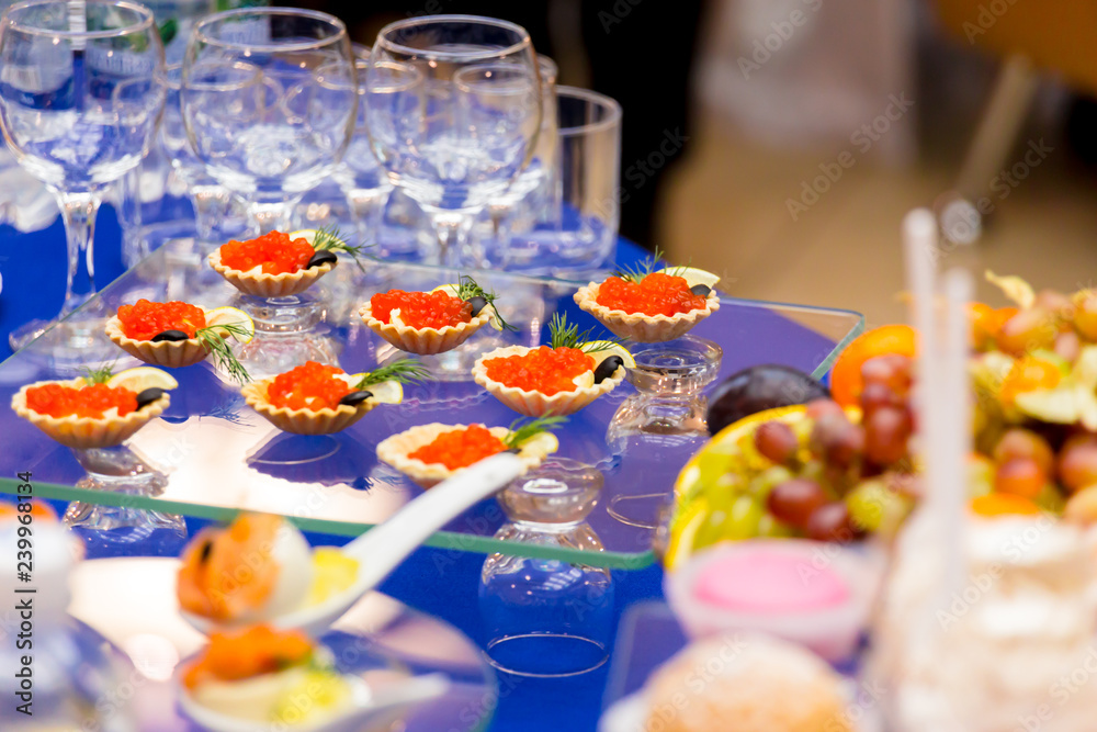 Red caviar on the table. Delicacies and Cutlery at the buffet. Catering.