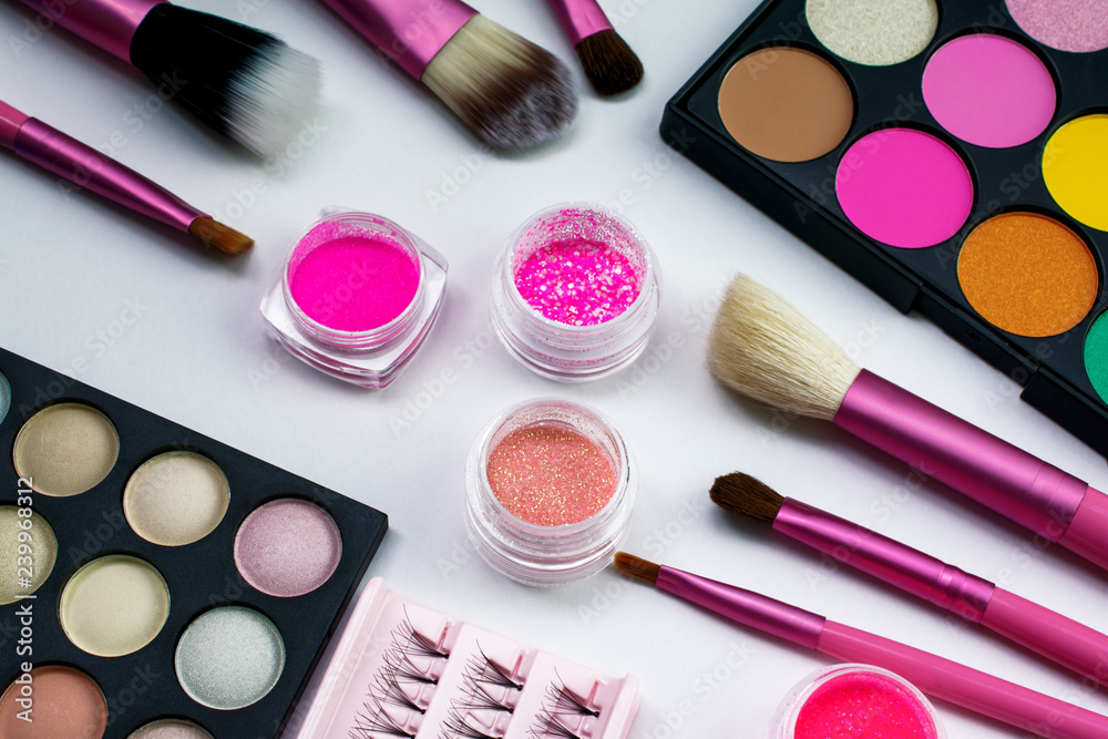 Makeup. Pink make up brushes. Eye shadow. Pink pigments, eyelashes. Beautiful bright background Makeup. Pink make up brushes. Eye shadow. Pink pigments, eyelashes. Beautiful bright background