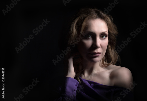 Middle aged woman portrait on black background