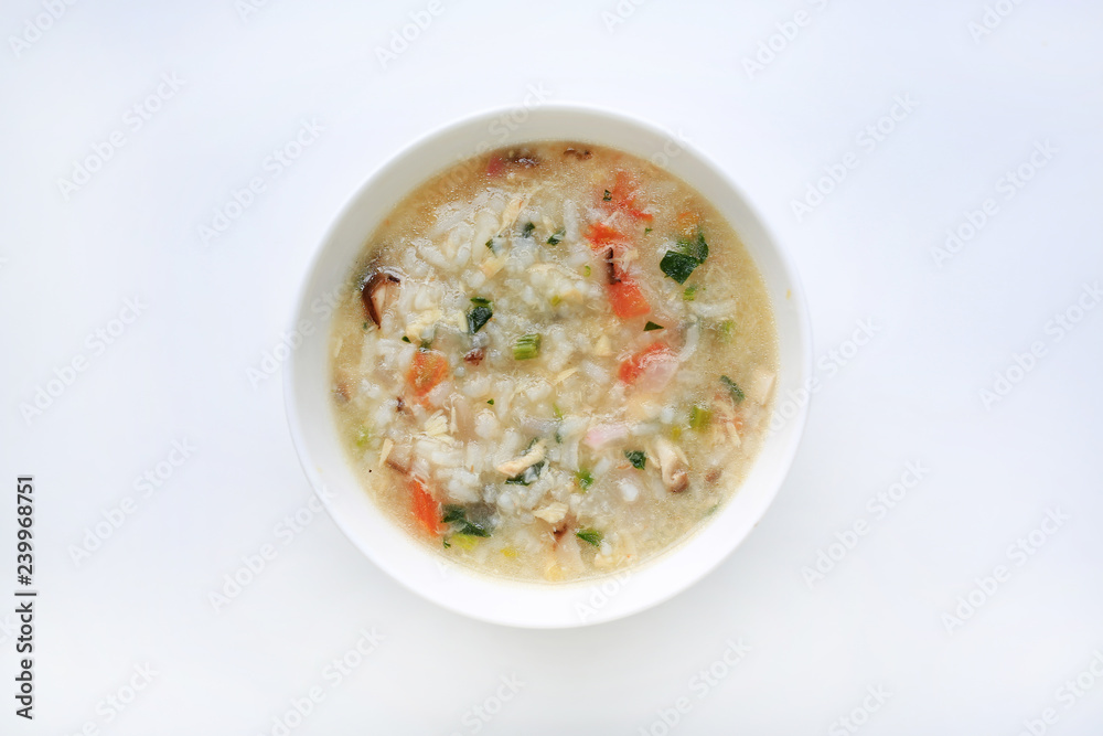 Porridge for baby food in white ceramic bowl on white background.