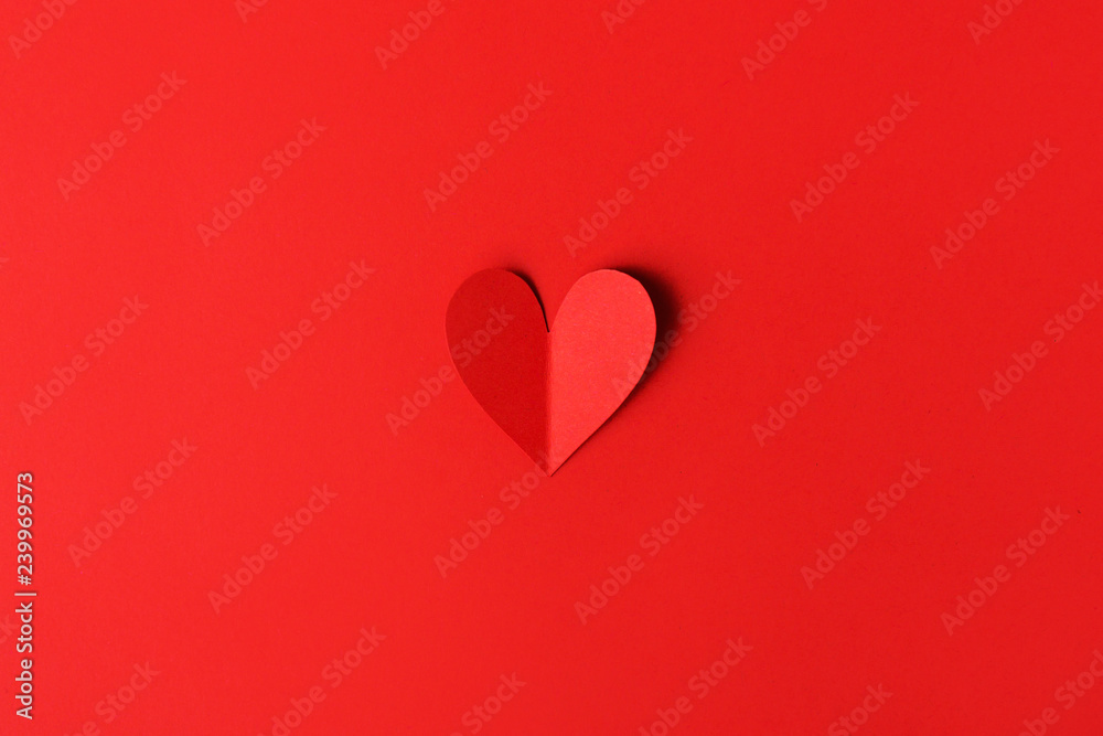 Paper valentines day hearts on red
