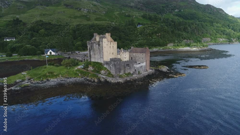 Slow drone shot approaching iconic Eilean Donan castle in highlands Scotland Slow drone shot approaching iconic Eilean Donan castle in highlands Scotland