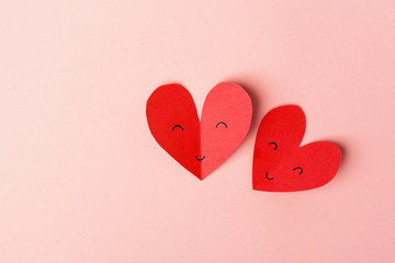 Paper valentines day hearts on pink