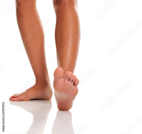 Beautiful woman legs and feet on white background © vladimirfloyd