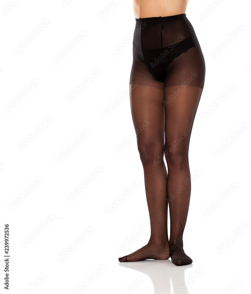 pretty female long legs and black high waist nylon stockings on white background pretty female long legs and black high waist nylon stockings on white background