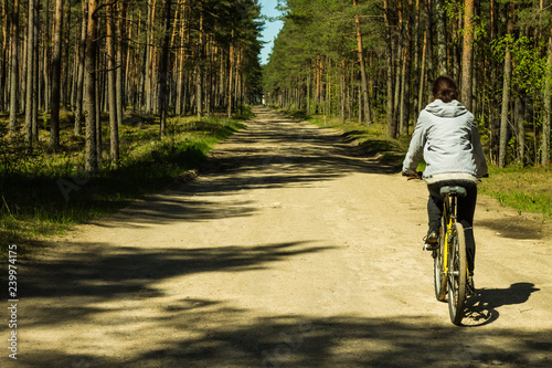 Young women cycling in the forest © Evija