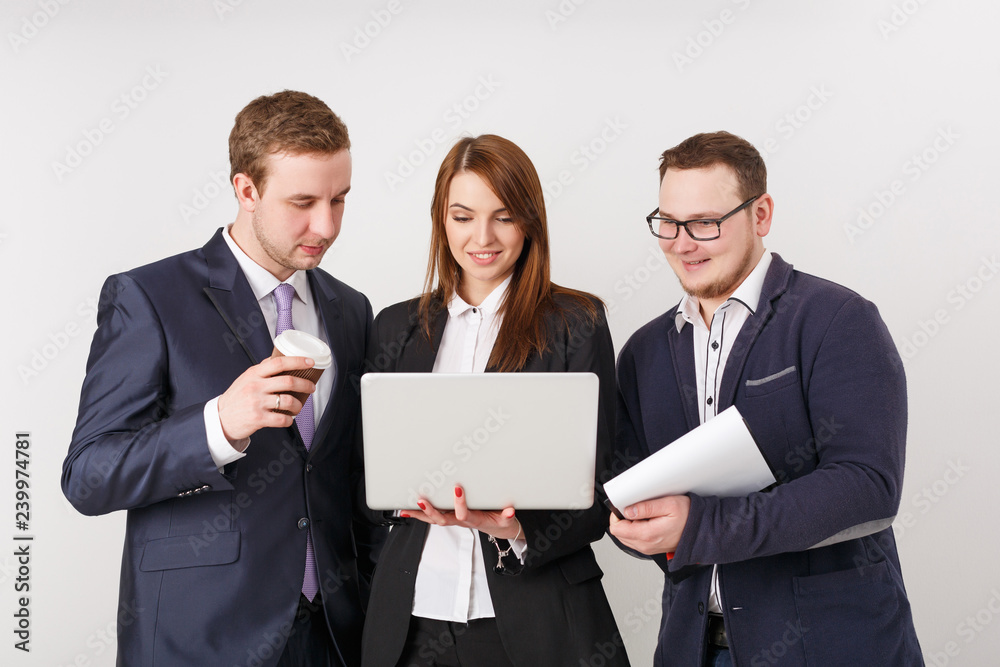 Business people looking at laptop and smiling Business people looking at laptop and smiling
