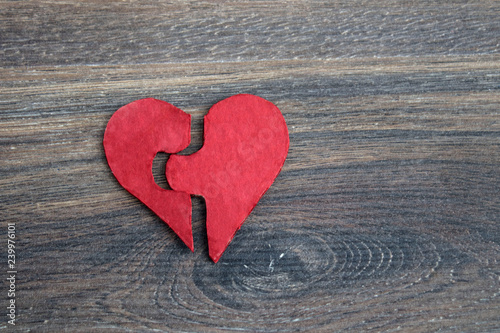 Red puzzle heart on grey wooden background