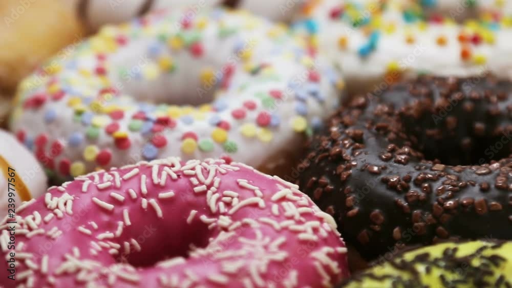 assorted donuts with different fillings and icing. Rotation video