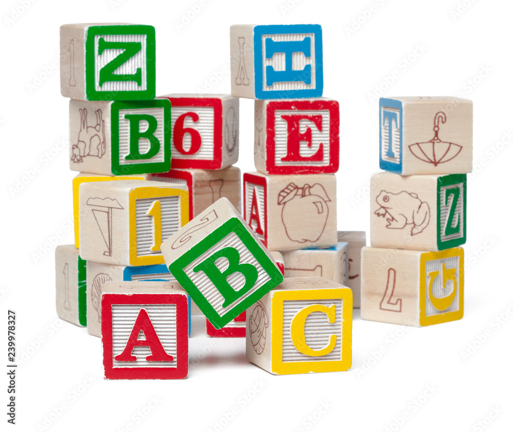 Colorful alphabet blocks stacked in a mess isolated on white background Colorful alphabet blocks stacked in a mess isolated on white background