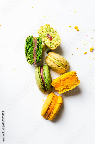 three colors macarons in a cut, close up, fillings on a white background photo