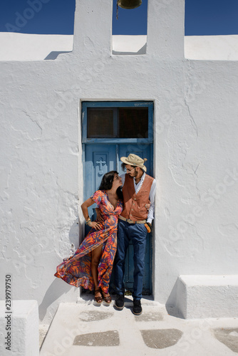 Young couple looks down on the landscape of the island of Santorini © wolfhound911